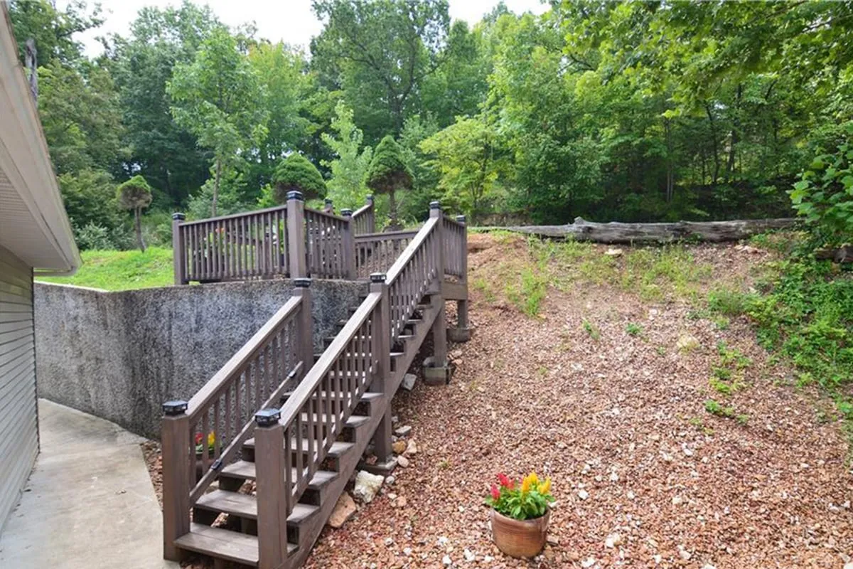 This exterior scene features a welcoming wooden staircase lined with a flower pot and surrounded by leafy greenery. The inviting pathway suggests easy transitions between indoor and outdoor spaces, ideal for coming and going as you explore the local nightlife.